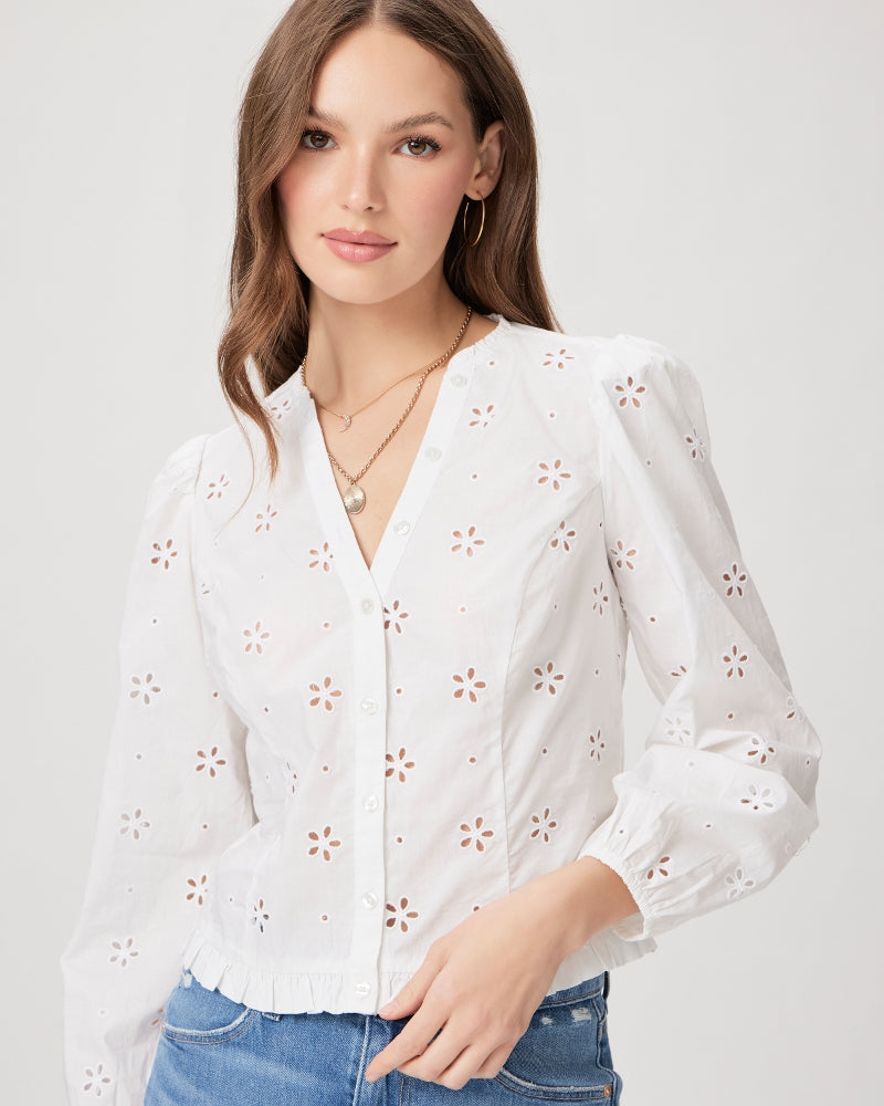 The Juno Blouse from Paige is a crisp white button up top that features a slightly cropped length, ruffle detailing and 3/4 length sleeves. With a feminine floral eyelet pattern throughout this blouse is crafted from 100% cotton. The fitted silhouette pairs perfectly with wide leg jeans or trousers.