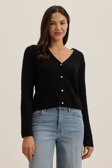 This gorgeous little black cardigan from Velvet by Graham &amp; Spencer will quickly become a go to piece.&nbsp; With a flattering v neck and pretty faux pearl buttons this looks equally good on it's own as it does over a little cami.&nbsp; Perfectly paired with your favourite wide leg denim for an elevated yet relaxed vibe.