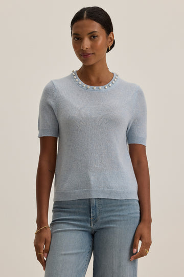 What a pretty flirty and feminine knit from Velvet by Graham &amp; Spencer.&nbsp; Crafted from a super soft cashmere blend and featuring faux pearls at the neck and a flattering short sleeve this looks great with white denim or a printed silky skirt.&nbsp;&nbsp;