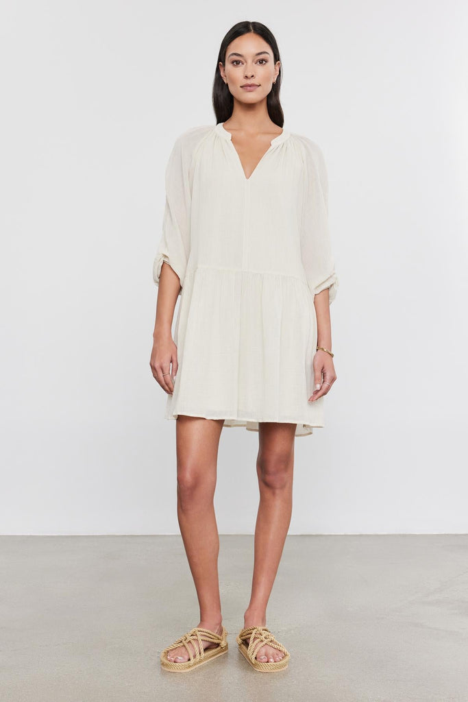Be warm weather ready with the lovely Sloan Dress.&nbsp; Crafted from super soft breathable cotton gauze and featuring 3/4 length sleeves with pleating details, a over the knee length and a flattering v neck.&nbsp; In a very wearable neutral colour this is the perfect dress for a hot Summer day!