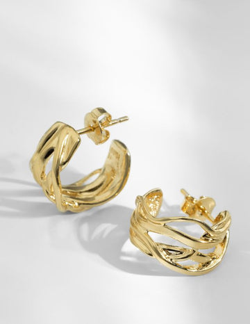 The Nami Small Hoop Earrings are perfect for everyday!  Featuring wrap around interwoven lines and hand made in Louise Damas' Parisian workshop from recycled brass gilded with 24k fine recycled RJC certified gold.  The clasps and fastening rods are 925 silver thus avoiding any allergy risk.  