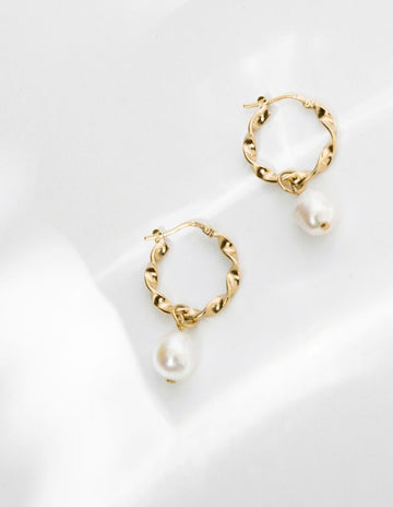 Featuring a twisted bit of gold with a pretty mother of pearl pearl dangling at the bottom.  Classic and timeless.    Handcrafted in Louise Damas' Paris workshop these lovely earrings are gilded in recycled 24k fine gold RJC certified onto brass. 