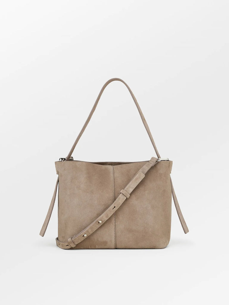 The Suede Fraya Small Bag is a spacious bag, has a magnetic closure and consists of 4 compartments and a zipped pocket. It can be worn as a shoulder or crossbody bag and the strap is adjustable.  The colour will pair perfectly with all your neutrals.  