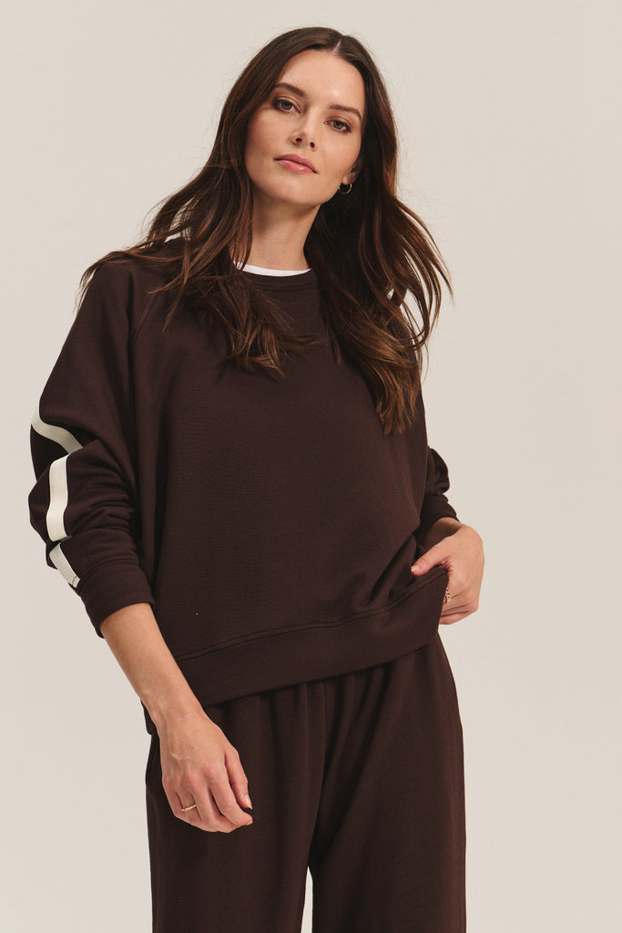 This super comfy sweatshirt is crafted from a cozy fleece fabric and comes in a gorgeous dark brown with stripe detail.&nbsp; An elevated weekend essential.&nbsp; Pair with the matching Gigi trousers (in store exclusive) for a put together co-ord.