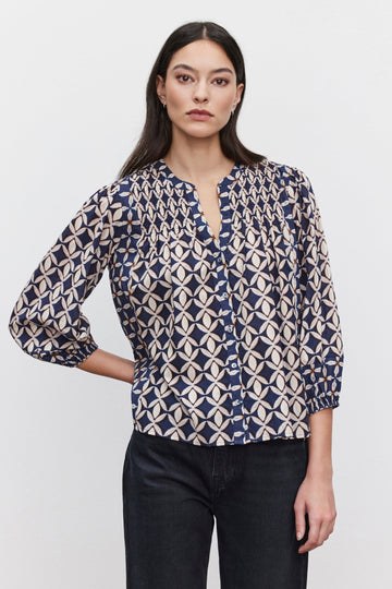 Crafted from printed cotton cambric the Haddon Blouse is elevated casual wear at it's finest.&nbsp; Featuring a split neck, button front, charming smock detailing, 3/4 sleeves and elastic at the cuff this easy to wear blouse has a relaxed fit and is perfect with your favourite denim.