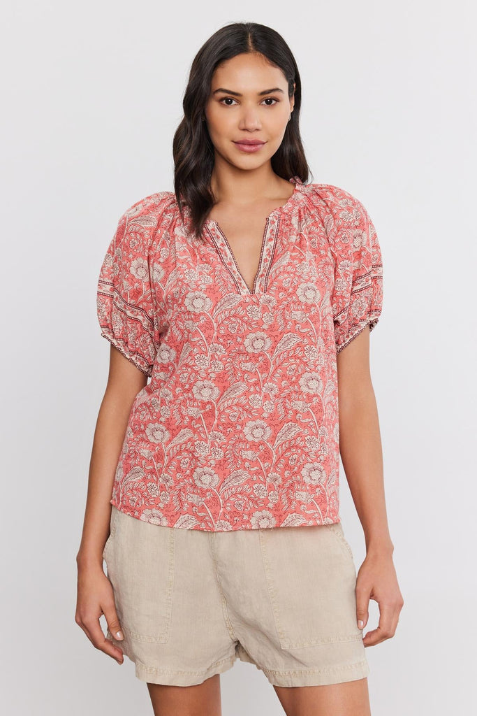 Pretty and feminine, the Lyra blouse from Velvet by Graham &amp; Spencer is just the ticket for lightening up your wardrobe as we move into the warmer months.&nbsp; &nbsp;Crafted from printed cotton voile this super soft blouse features a flattering v neck, elastic cuffs and a relaxed shape.&nbsp; Perfect paired with your favourite shorts or denim!&nbsp;