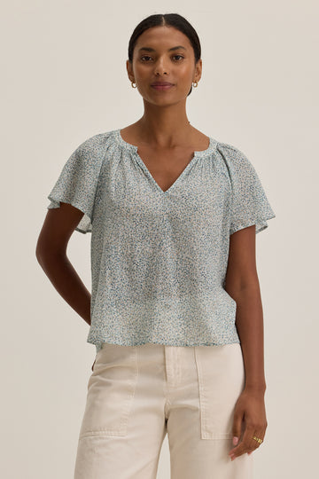 What a pretty print from Velvet by Graham &amp; Spencer!&nbsp; Crafted from their signature super soft fabric and featuring a flattering v neck, short ruffle sleeves and a relaxed shape this looks great paired with your favourite denim.