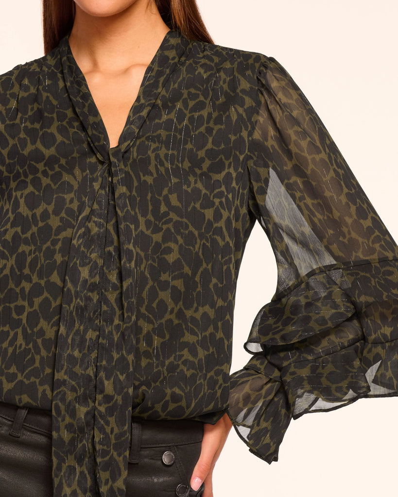 Flirty and romantic the Foliage Bonnie Blouse from uber cool New York City brand Ramy Brook features sheer sleeves, ruffle detail and an optional self tie at the flattering v neck.&nbsp; Perfect for an evening out - pair with black trousers or denim for that classic jeans and a great top look!