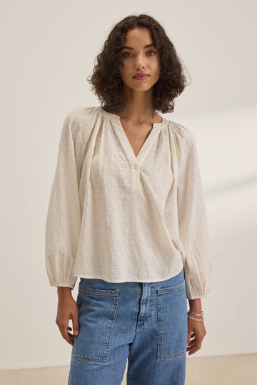 The Carina Cream Blouse from Velvet by Graham &amp; Spencer is definitely giving serious relaxed Summer vibes.&nbsp; Crafted from the signature super soft fabric and featuring a flattering v neck and a relaxed shape this looks great with your favourite denim shorts.