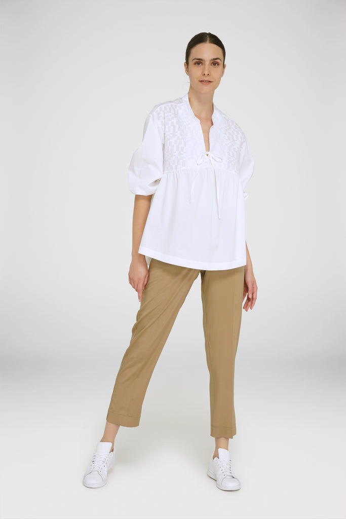 Gorgeous 100% cotton blouse with a flattering v neck, elasticated puff sleeves, v neck and tie detail.  This relaxed top looks perfect paired with a slim trouser or a skinny jean.  The fabric is just gorgeous and perfect for the warmer months.