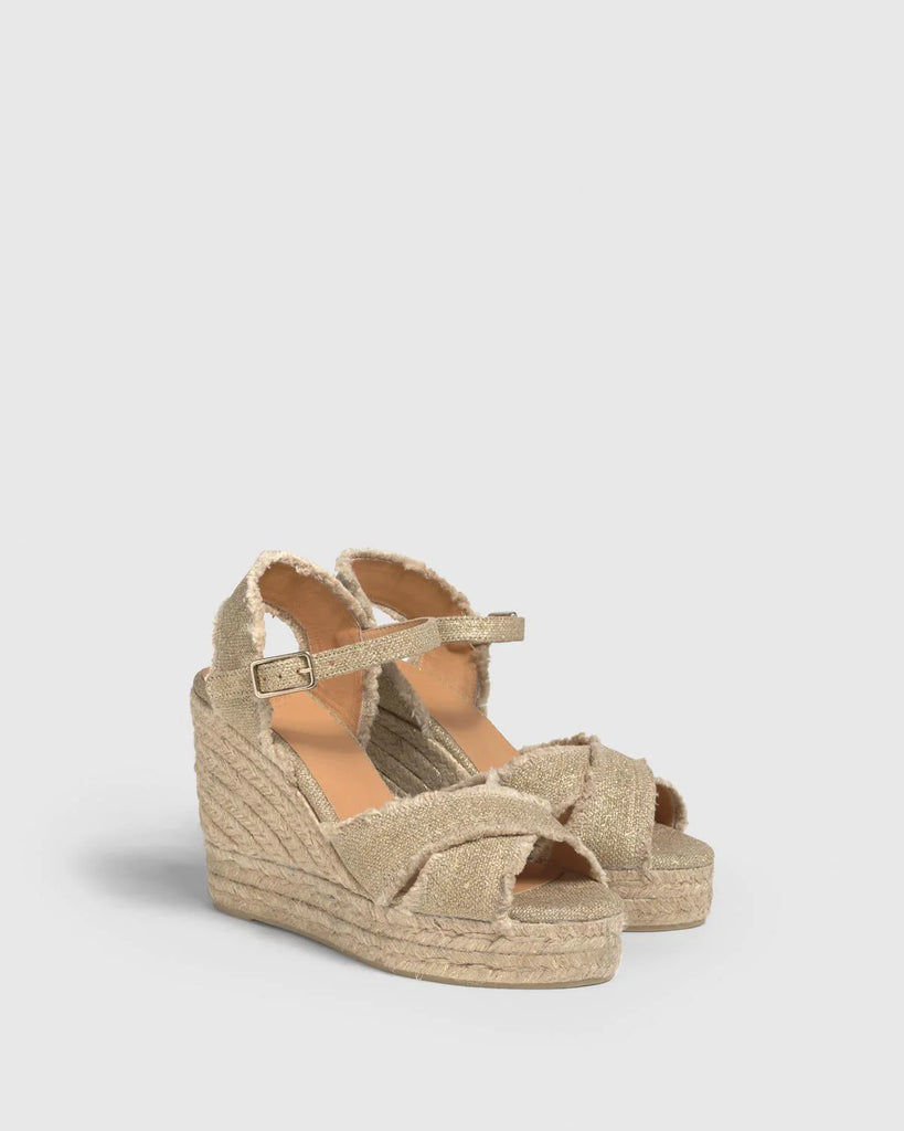 One of Castaner's signature styles, the Bromelia, is crafted from lightweight frayed metallic linen with a woven jute wedge heel and a buckle fastening.  Wear these literally with everything from wide leg jeans to dresses!  