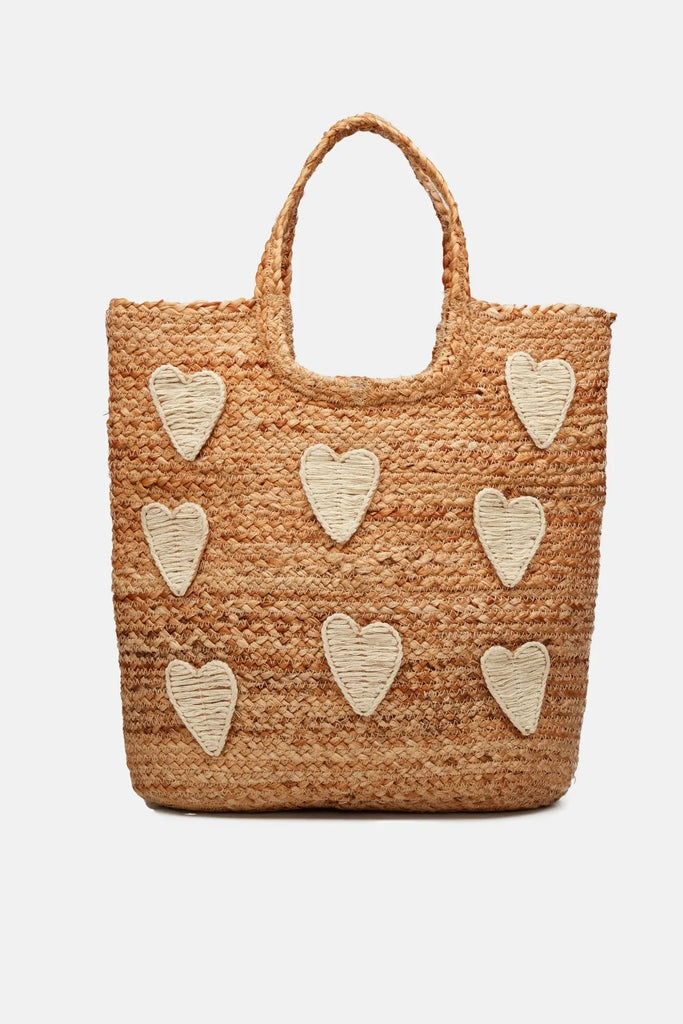 This spacious Magic Straw Bag from Fabienne Chapot features cream embroidered hearts and has a large compartment. It is made of 100% wicker making it the perfect beach or shopper bag!