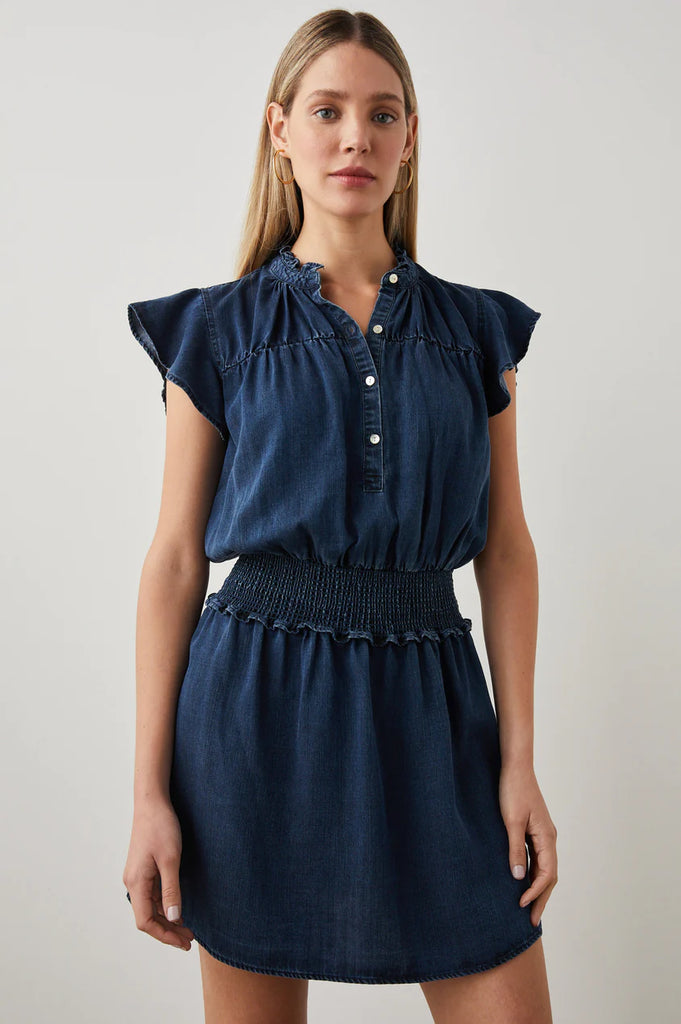 The Amina Dress from Rails is a summer wardrobe staple! Made from sustainable Tencel denim this dress is lightweight and comfortable. Featuring ruffle details, flouncy cap sleeves, a banded collar and a smocked waistband - this dress is easy-to-wear all day long.