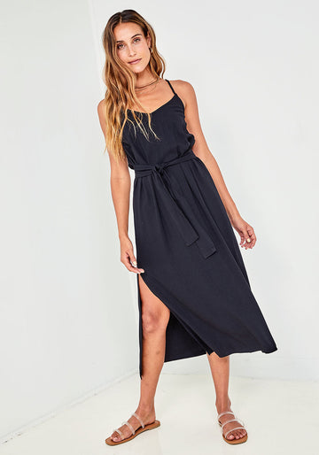 Another super easy to wear but stylish midi dress from Bella Dahl.  Crafted from their signature soft fabric and featuring a v neck, side slits, adjustable straps and a belted waist with smocking at the back this is a perfect throw on and go.  Great for day but pair with a heel and you're ready for your evening.  Flirty and fun! 