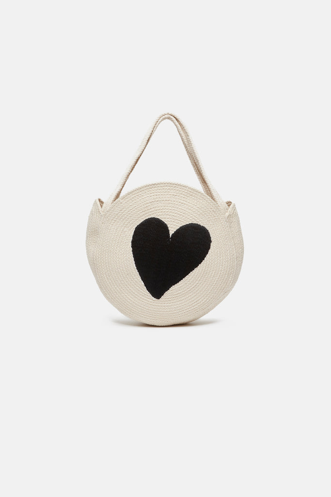 The Bonnie Mini Heart Bag by Fabienne Chapot is made from 100% cotton. This round braided bag with handles features a black heart motif on the front. The Bonnie bag is the perfect practical accessory for the beach.