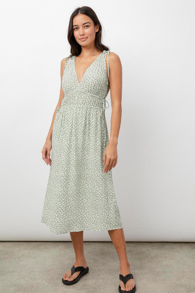 This pretty summer midi dress from Rails features a green ditsy floral print, a v-neckline, a concealed adjustable waist band and adjustable ruching at the sleeve. This is the perfect dress to style with white trainers for a more casual look or dress up with a pair of heeled sandals.