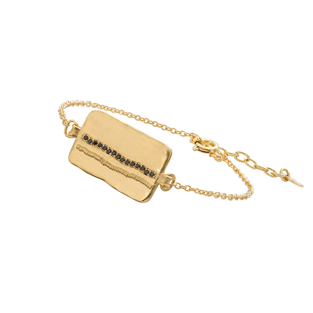 The Elvis Collection definitely deserves a place in your jewellery box! The bracelet features a rectangular gold piece with tiny black zirconias in a row on an extendable chain.  Pair with the matching necklace for a put together look!