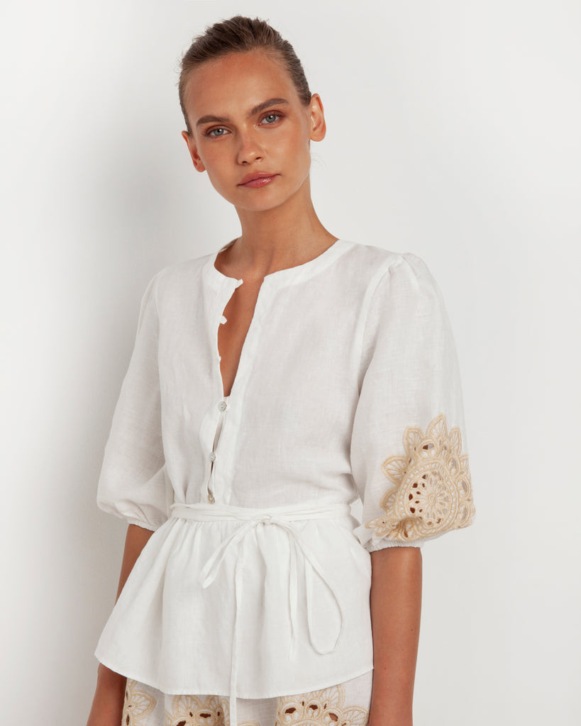 This pretty linen blouse from Greek Archaic Kori features a half-button v-neck and striking embroidery on the balloon sleeves.  It can be worn with the belt or left loose.  Pair with your favourite denim or shorts and a pair of sandals or flip-flops for a lovely summer look.