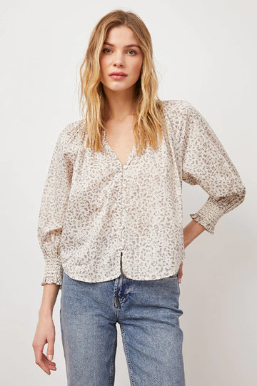 This ultra lightweight, slightly sheer textured cotton, v-neck top from Rails features a subtle cheetah print, a smocked neckline, full sleeves with raglan seam and natural shell loop buttons. This pretty pullover top mixes animal prints with feminine details for the ultimate summer style.