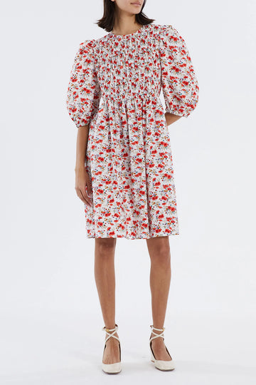 The Mischa Dress from Lollys Laundry is designed with a smocked bodice and a round opening at the back with a button fastening. The slight puff at the shoulders, balloon sleeves and floral print make this dress super feminine. Wear with trainers for a casual vibe or sandals for those dressier occasions.