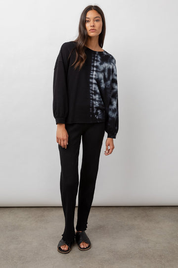 This super soft jet black crew neck sweatshirt features a white tie dye design, a dropped shoulder, full sleeves and a raw hem. This over-sized pullover is a perfect loungewear piece for relaxing at home but is just as amazing to wear going about your day.