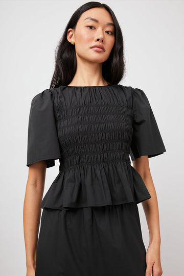 We love a pretty top and the Rosie from Rails does not disappoint.  With a flattering silhouette that works for day or evening and made from crisp cotton poplin and featuring wide short sleeves, smocking detailing throughout the body and flare and ruffle along the hem this is perfect paired with your favourite denim or pair with the matching Rhea Skirt and you have a pretty dress!