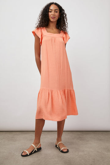 Effortless dressing at it's best!  Crafted from super soft double cotton gauze the Skylar Midi couldn't be more comfortable.  Featuring a square neckline, little flutter cap sleeves and a ruffle detail at the hem and in a pretty peachy colour this is perfect to throw on with your favourite trainers and face the day in style!