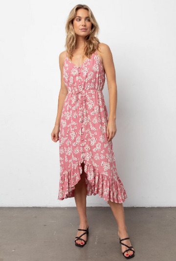 Sleeveless, V-neck, midi-length pink floral printed dress featuring thin adjustable shoulder straps, fabric covered buttons down the center front, a drawstring self-tie waistline, and a flowy bottom hem. Soft skirt lining. Feminine and flowy, this style is the perfect day-to-night dress. 