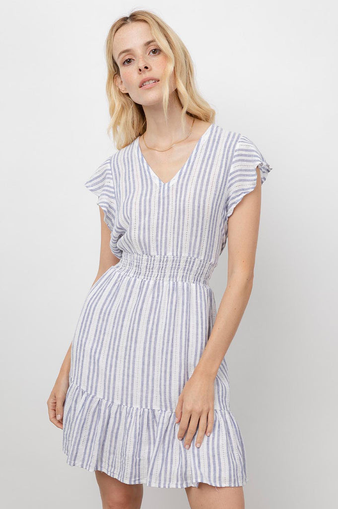 Super cute lightweight linen short sleeved dress from our favourite LA brand Rails.  With a flattering v neck, flutter cap sleeves, a smocked elasticated waist and feminine ruffle detail at the hem this is an incredibly easy dress to wear.  Pair with your favourite trainers for a relaxed daytime look.