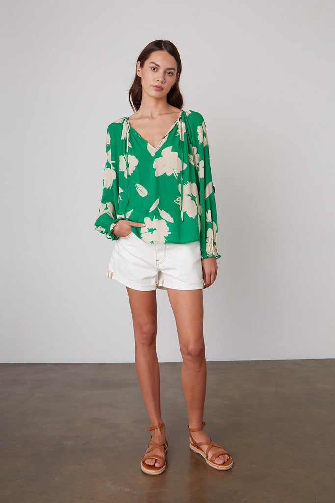 Vikki definitely stands out in a crowd.  This pretty blouse from Velvet in a bright kelly green with a floral print features a flattering v neck, cut out detail on the sleeves and a relaxed shape.  It's perfect paired with your favourite white denim.