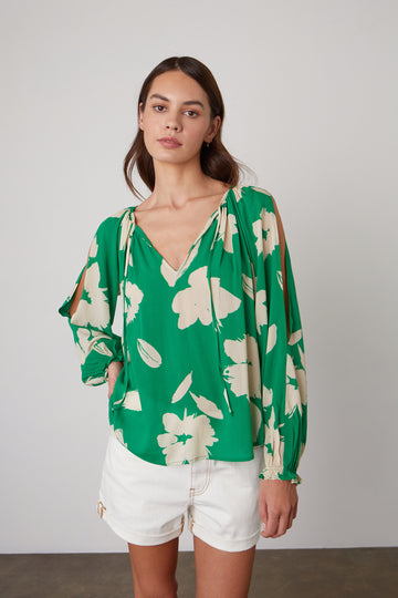 Vikki definitely stands out in a crowd.  This pretty blouse from Velvet in a bright kelly green with a floral print features a flattering v neck, cut out detail on the sleeves and a relaxed shape.  It's perfect paired with your favourite white denim.