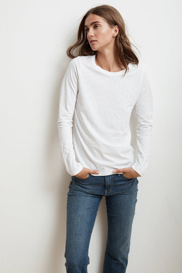 The perfect long sleeved tee from Velvet by Graham & Spencer.  Crafted from their signature super soft cotton slub this is a great tee on it's own and equally great for layering. Flawless fit and featuring a contrast band around the neckline and hemline that hits the hips in just the right spot.  You'll want this in every colour.