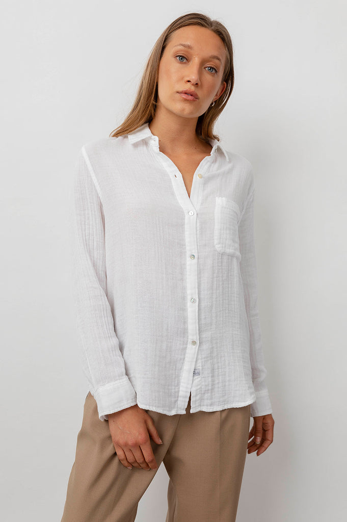 Yes please may we have a new white shirt!  Super comfy 100% cotton gauze button down shirt in always wearable white.  Featuring a classic feminine fit, patch pocket at the chest and a longer back hem this looks great paired with your favourite denim.  A classic for elevated comfort.