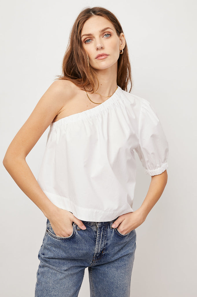 Say hello to Jayla!  This flirty little one shoulder number is crafted from lightweight, cotton poplin and will look fab with your favourite high waited denim or skirt.  Featuring a puff sleeve with elastic at the opening in always wearable white this is perfect for day or evening.