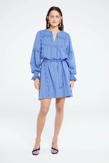 This short blue dress from Fabienne Chapot features long sleeves, a bow belt and a v-neckline with added bow detail. The Jeanine Dress has beautiful openwork details and elastic at the cuffs. 