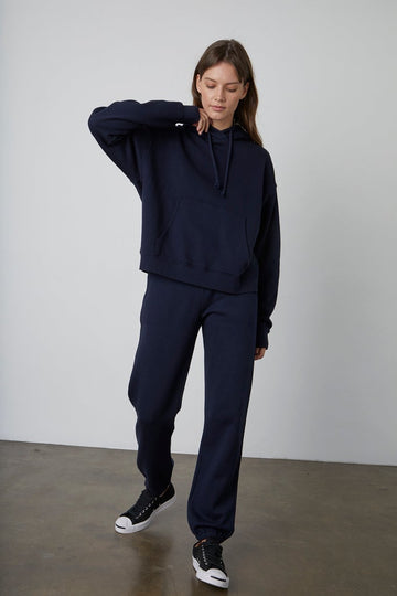 This perfect everyday hoodie has a  relaxed fit with a slight crop to the waist. This cosy hoodie features a chunky cinch cord and an essential kangaroo pocket, perfect for keeping you warm throughout the year. 