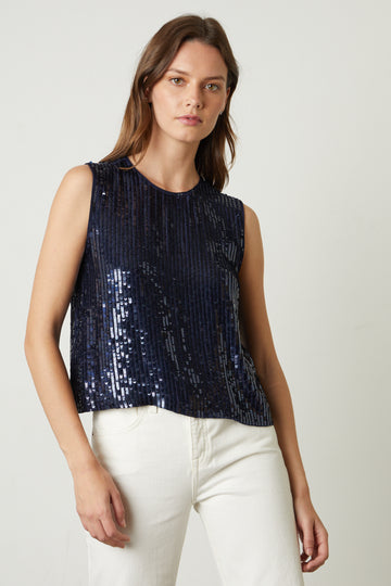 The Maison Sequin Top from Velvet by Graham & Spencer features a high neckline, a sleeveless cut and a slightly cropped length. This top is perfect for this coming party season! Pair with jeans and heels and you are ready-to-go. 