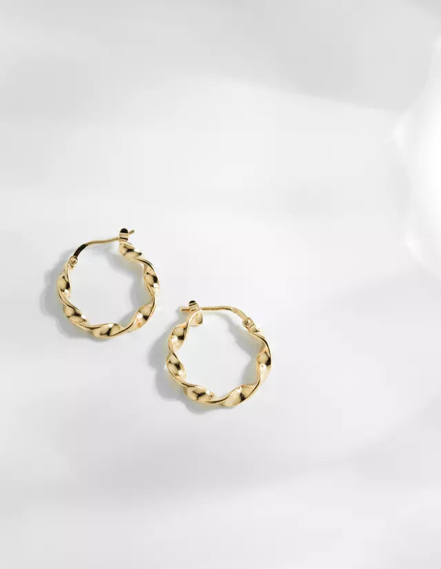 The Esmeralda small twisted hoop earrings are Louise Damas' signature piece! Both minimalist and original, its twist has already turned more than one head. Each Esmeralda hoop earring is unique: the twist is made by hand and can therefore vary from one piece to another.