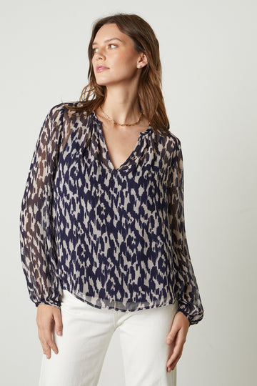The Edna Blouse in Calico from Velvet by Graham & Spencer features a v-neckline and long sleeves with a delicate buttoned cuff. The jeans and a nice top combination never goes out of style and this is a perfect one to add to your collection. 